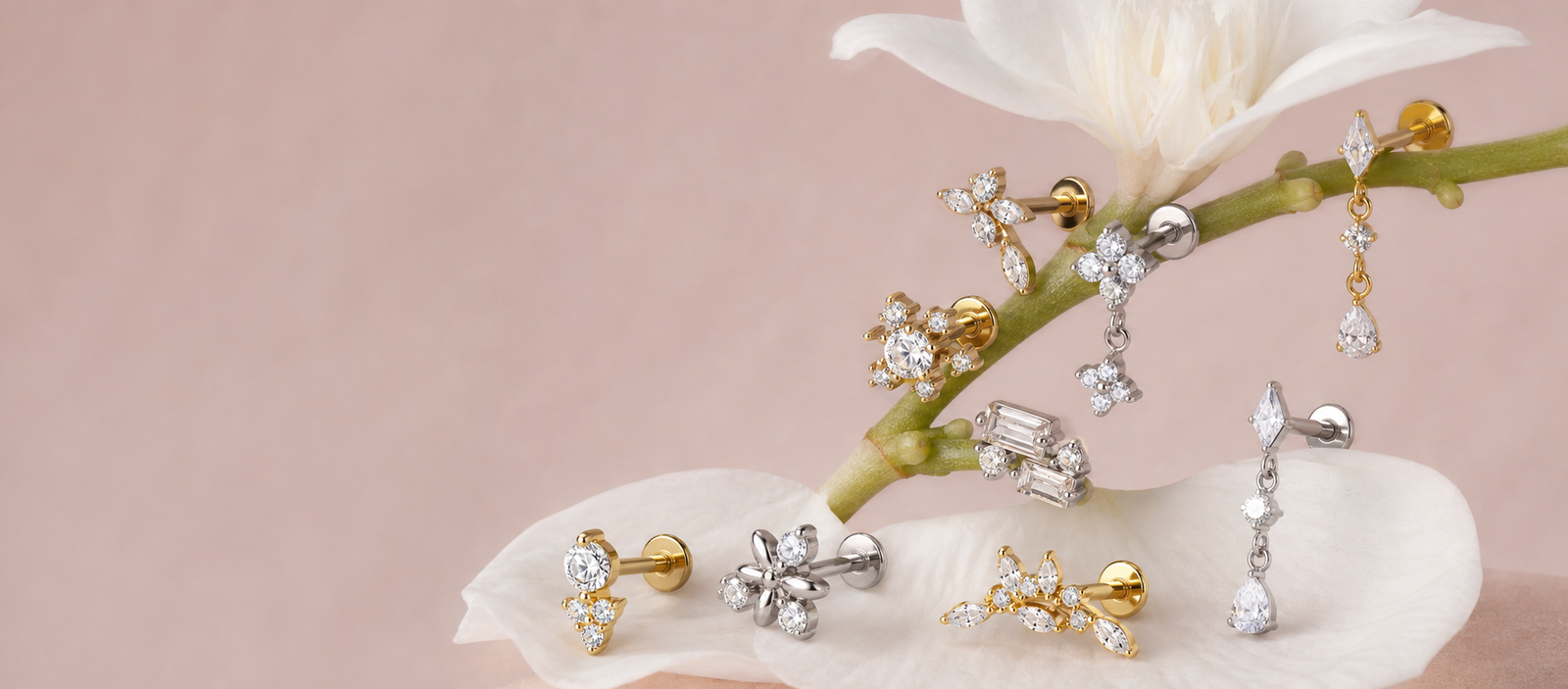 Gold and silver designer flat back labret jewelry arranged naturally on white flowers